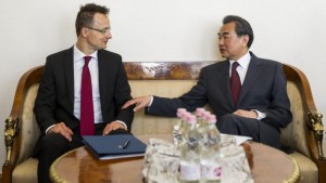 Hungarian Minister of Foreign Affairs and Trade Peter Szijjarto, left, and Chinese Foreign Minister Wang Yi meet for talks in the Ministry of Foreign Affairs and Trade in Budapest, Hungary, Saturday, June 6, 2015. (Zsolt Szigetvary/MTI via AP)