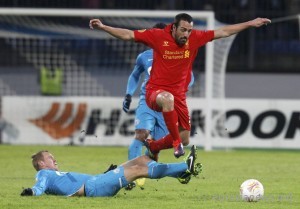 Zenit St. Petersburg's Aleksandr Anyukov fights for the ball with Liverpool's Jose Enrique during their Europa League soccer match at the Petrovsky stadium in St. Petersburg