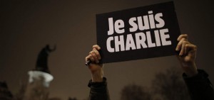 A man holds a placard which reads "I am Charlie" to pay tribute during a gathering at the Place de la Republique in Paris